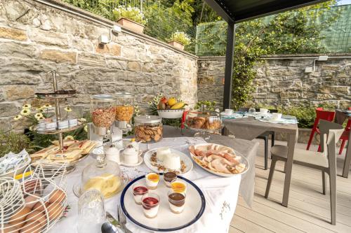 a table with plates of food on a patio at Villa Bonafata b&b in Trieste