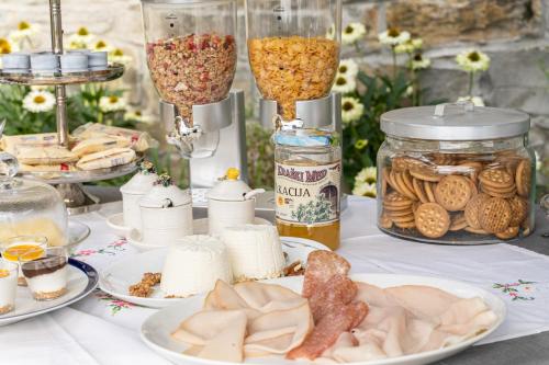 a table topped with plates of food and desserts at Villa Bonafata b&b in Trieste