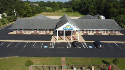 an overhead view of a gas station with cars parked in a parking lot at Days Inn by Wyndham Savannah in Savannah