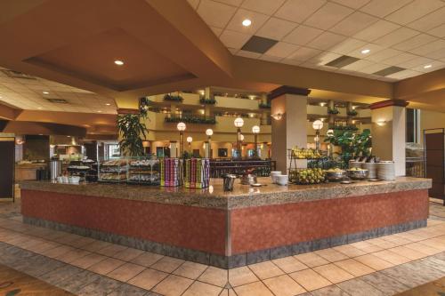 a restaurant with a counter with food on it at Embassy Suites by Hilton Portland Airport in Portland