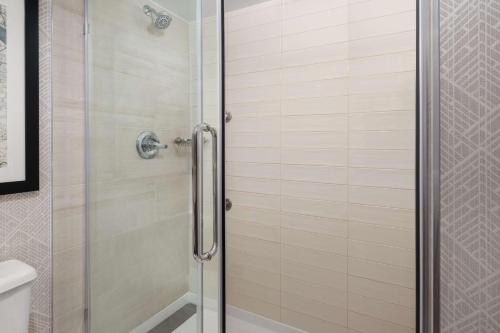 a shower with a glass door in a bathroom at Embassy Suites by Hilton Portland Airport in Portland