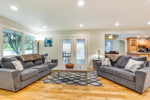 a living room with two couches and a table at Twin Falls Vacation Rental with Yard Less Than 3 Mi to Town! in Twin Falls