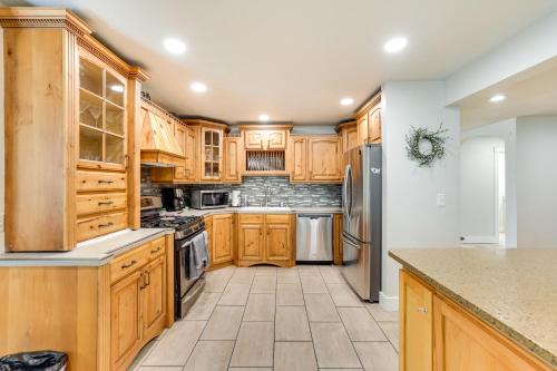 a kitchen with wooden cabinets and a tile floor at Twin Falls Vacation Rental with Yard Less Than 3 Mi to Town! in Twin Falls