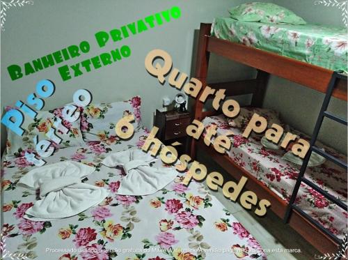 a bedroom with two bunk beds with flowers at Pousada Seu Jorge in Campinas
