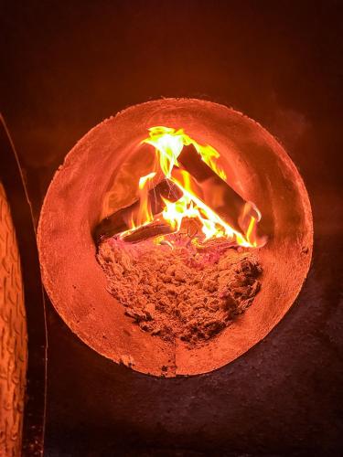 a fire in a clay pot with flames in it at Unicorn Reborn - Peaceful Rentals in San Marcos La Laguna