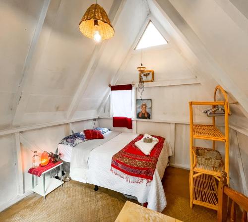 a bedroom with a bed in a attic at Unicorn Reborn - Peaceful Rentals in San Marcos La Laguna