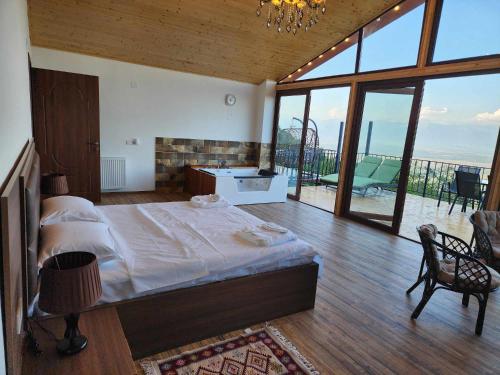 a bedroom with a bed and a bathroom with a balcony at Guest House Kusika in Sighnaghi