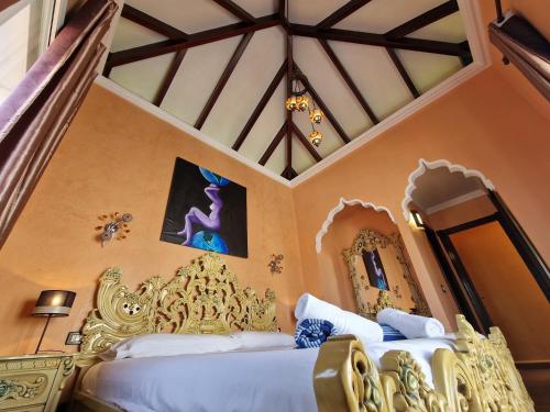 a bedroom with two beds and a ceiling at Villa Habibi Luxury 5A in Chayofa