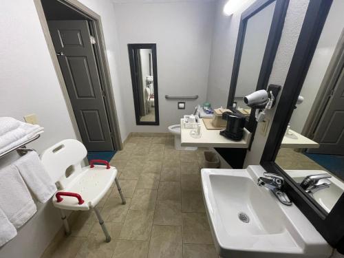 a bathroom with two sinks and a mirror at Days Inn by Wyndham Savannah in Savannah