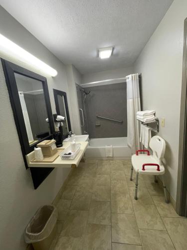 a bathroom with a toilet and a sink and a shower at Days Inn by Wyndham Savannah in Savannah