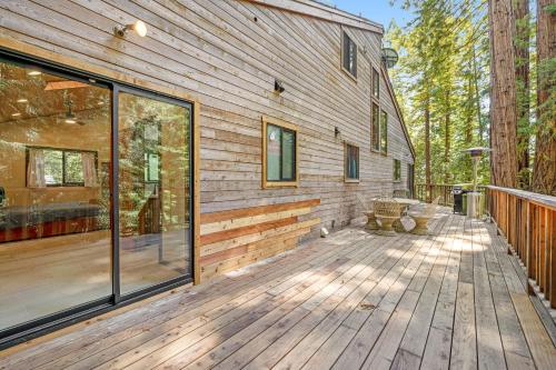 a wooden deck with a bench on the side of a house at Sequoia Sunset in Gualala
