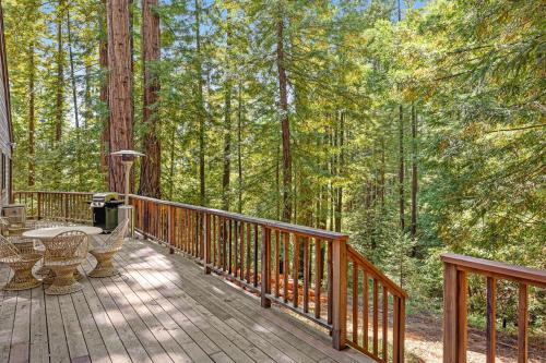 a wooden deck with a table and chairs on it at Sequoia Sunset in Gualala
