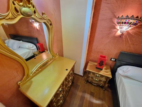 a hotel room with a mirror and a bed at Villa Habibi Luxury 5B in Chayofa