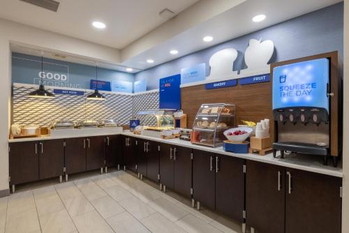 an apple store with a counter with food on it at Holiday Inn Express Rochester South - Mayo Area by IHG in Rochester