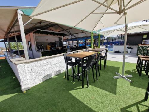 a group of tables and chairs under an umbrella at Villa Habibi Luxury 5B in Chayofa