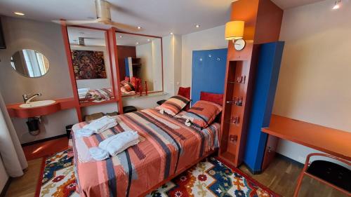 a bedroom with a bed and a sink and a mirror at BeautyD RED ROOM centrum Gullegem in Wevelgem