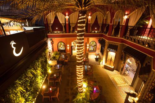 an overhead view of a building with a palm tree at Exótica Boutique Hotel in Pipa