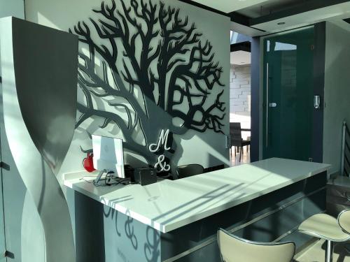 a office with a tree mural on the wall at Hotel Boutique M&F in Tequisquiapan