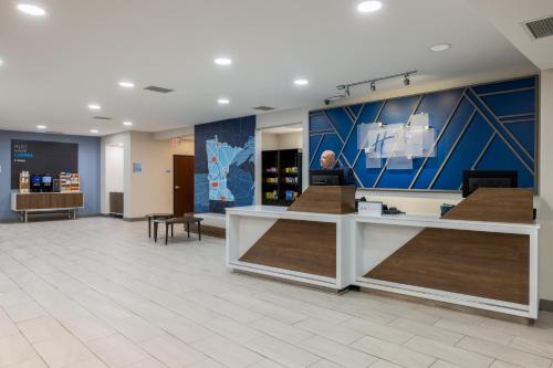 a lobby of a store with a counter in the middle at Holiday Inn Express Rochester South - Mayo Area by IHG in Rochester