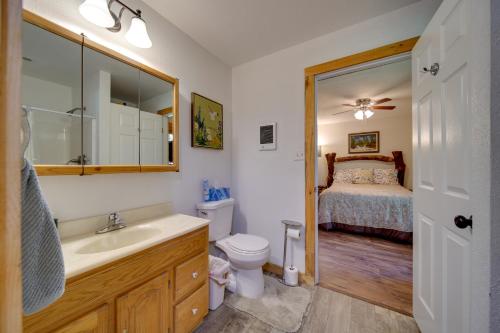 a bathroom with a sink and a toilet and a bed at Cozy Countryside Cabin in Robie Creek Park! in Boise
