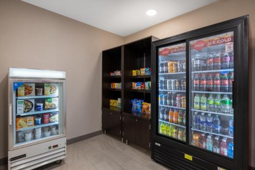 a room with two refrigerators with soda and drinks at Holiday Inn Express Rochester South - Mayo Area by IHG in Rochester