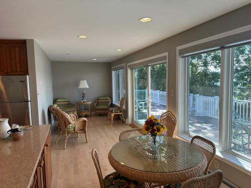a kitchen with a table and a dining room with a table at Claddagh Cottage in Richfield Springs