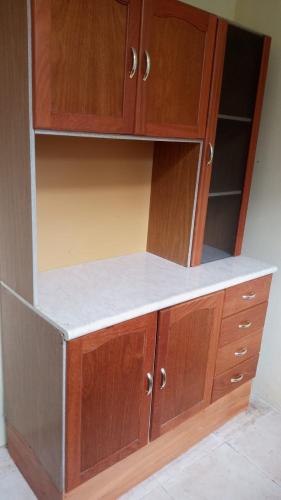 a wooden cabinet with wooden doors and shelves at Hermosa vista, casa en Boquete. in Boquete