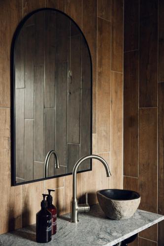 a bathroom with a sink and a mirror at Links House in Bowral