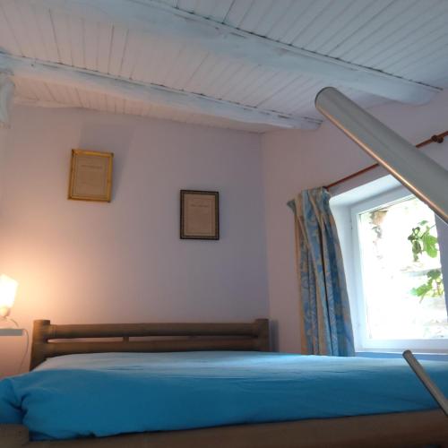 une chambre avec un lit et une fenêtre dans l'établissement Gite du colombier, à Usson