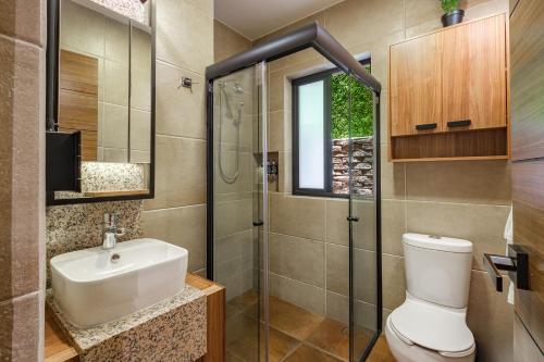 a bathroom with a toilet and a sink and a shower at Condesa Square by RentinBA in Mexico City