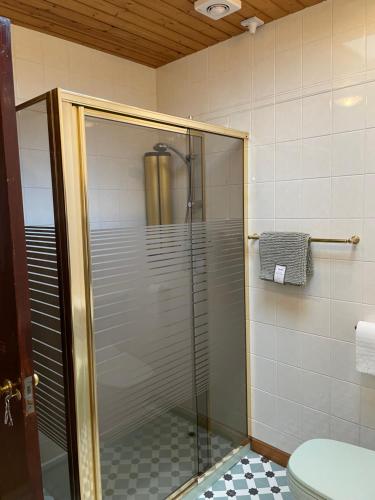 a glass shower in a bathroom with a toilet at The Old Manse B&B in Thurso