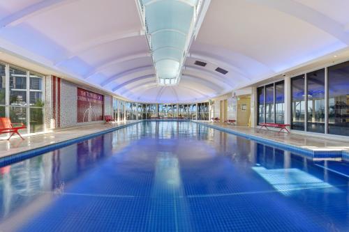 a large swimming pool in a building at Holiday Holiday Chevron Renaissance Apartments in Gold Coast