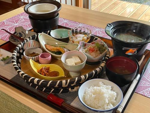 a tray of food on a table with rice at Harumiya Ryokan in Fukushima