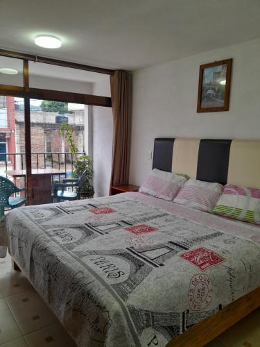 um quarto com uma cama com uma colcha em Hotel Posada Doña Maria Esther em Zacatlán