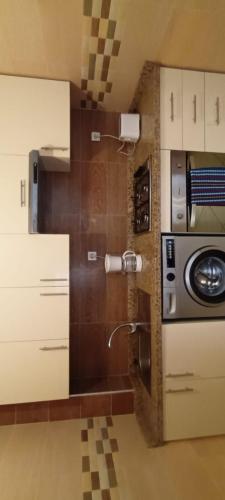 a kitchen with a sink and a microwave at Nour 2 in Oued Laou