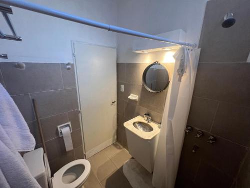 a bathroom with a sink and a toilet and a mirror at Quiet, Central Apartment To Feel Good - www_el-rincon_rentals in La Rioja