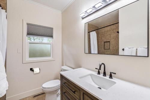 a bathroom with a sink and a mirror at Cinnamon Bear Creekside Inn in Sonoma