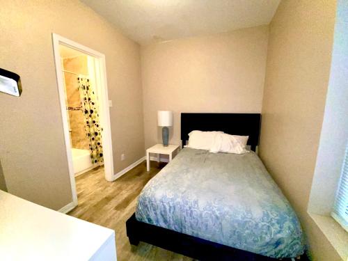 a bedroom with a bed and a bathroom with a tub at Downtown Hobart Cozy 1 Bedroom in Hobart