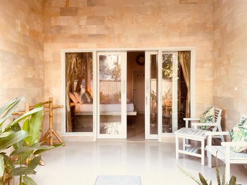 a room with glass doors with a bed in it at Follow Your Dreams Gili Air in Gili Islands