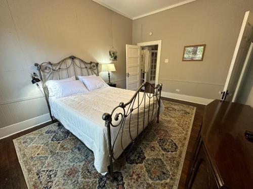 a bedroom with a bed with a metal frame at Blueberry Bungalow - Locally Run! Enjoy our PS5! in Taylor