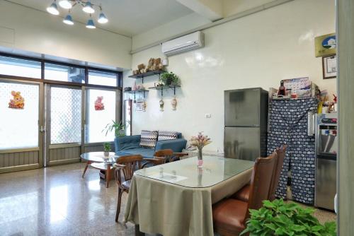 a living room with a table and a refrigerator at Wanghong Homestay in Hengchun