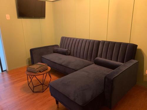 a living room with a couch and a table at Hotel Cocli in Roldanillo