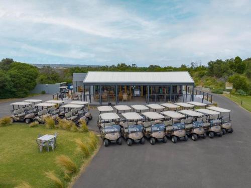 a group of trailers parked in front of a building at The Golf House at St Andrews Beach in Fingal
