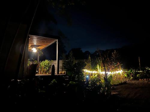 a small trailer with lights in a garden at night at Glamping Salento con jacuzzi climatizado in Salento