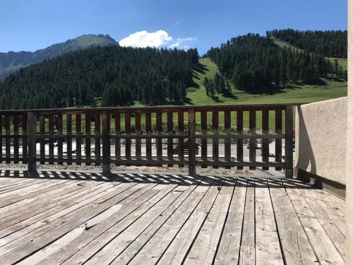 a wooden deck with a view of a mountain at Appartement Montgenèvre, 2 pièces, 5 personnes - FR-1-266-212 in Montgenèvre