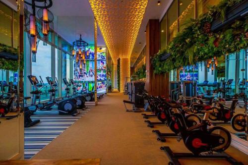 a gym with a row of treadmills and machines at The Riviera Jomtien one bedroom in Jomtien Beach
