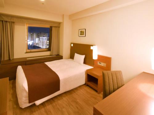 Ένα ή περισσότερα κρεβάτια σε δωμάτιο στο Sapporo View Hotel Odori Park