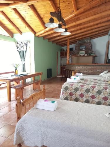 a room with two beds and a wooden ceiling at MAE in Esquel