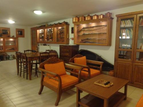 a living room with wooden furniture and a table at Faros in Milopotamos