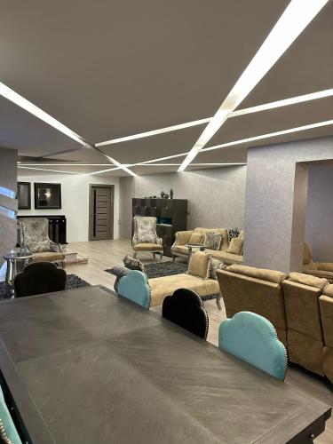 a large living room with a large table and couches at Trio villa with falls in compound فلا بحديقة كبيره وشلالات صناعية in Sheikh Zayed
